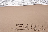 Strand, Sand mit Schriftzug SUN, X 