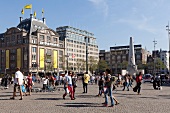 People walking on street of Dam square in front of Buenkorp departmental store, Amsterdam