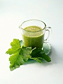Glass mug of green smoothie for muscle building