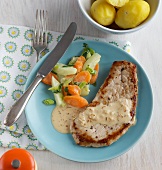 Boiled potatoes and schnitzel with vegetables on plate