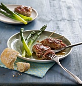 Saltimbocca with green asparagus on plate