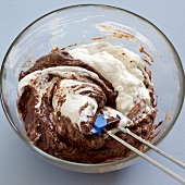 Close-up of egg whites with chocolate mixture in bowl