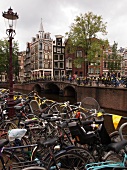 Canal houses and bicycles on bridge in Amsterdam, Netherlands