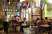 People at coffee house in evening at Corniche, Cairo, Egypt