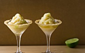 Caipirinha sorbet in cocktail glasses with decorated glass rim