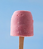 Close-up of fruit ice lolly against blue background