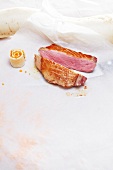 Pieces of duck breasts with skin on white sheet