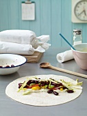Wraps with kidney beans on kitchen surface