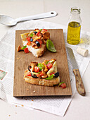 Bruschetta topped with chanterelle mushrooms, olives, artichokes and tomatoes