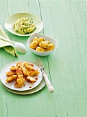 Asparagus and mashed potatoes with peas on plate, potatoes in bowl