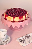 Cheesecake with cherries toppings on cake stand