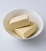 Two tofu blocks in bowl
