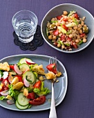Quinoa salad and bread salad in serving dish and bowl