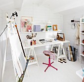 Desk and easel in artist's studio in Scandinavian summer house