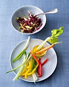 Raw vegetables with dip and insalata veronese on plate and bowl