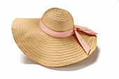 Straw hat with pink bow on white background