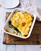 Baked potato with swiss chard in baking tray