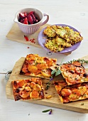 Stewed plums with potato pizza on wooden board 