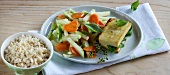 Tofu packet with vegetables and lemon on plate