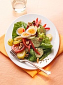 Potato salad with walnuts and egg on plate
