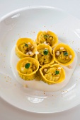 Close-up of anchovy tortelli with pepperoni on plate