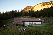 Man standing near house at chiemgau Alps mountain, Bavaria, Germany