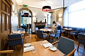Waiter setting tables at Viajante, London, UK, blurred motion