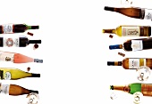 Variety of wine bottles and wine glasses on white background