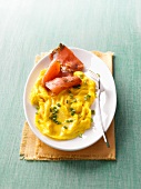Scrambled eggs with chives and gravlax on plate