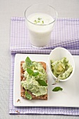 Avocado bread with mint on plate with glass of butter milk