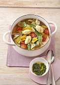 Vegetables soup with cheese dumplings and ginger in wok