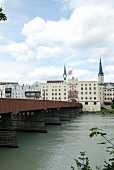 Woman walking on street in front of Wasserburg am Inn in Rosenheim, Bavaria, Germany