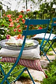 Cushions & tray on folding chair in summery garden