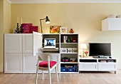 White wall unit with shelves and laptop desk and TV on TV bench
