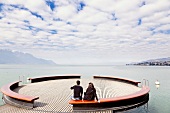 People sitting on bench at Lake Geneva, Montreux, Riviera-Pays-d'Enhaut, Canton of Vaud