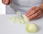 Peeled onions being finely chopped