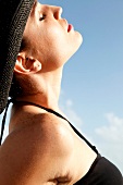 Woman in a black bikini relaxes in the sun