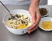 Ingredients being mixed with butter while preparing wurz butter, step 1
