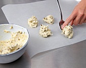 Close-up of dumplings of butter and other ingredients being made on baking paper