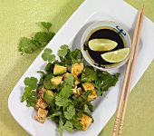 Green salad with tofu in serving dish