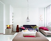 Living room with white fireplace, sofa and hanging lamp