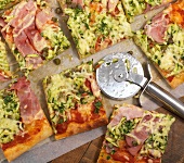 Slices of pizza with zucchini and ham