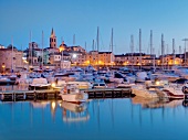 View of Alghero harbour with boats in Mediterranean sea in Sardinia, Italy