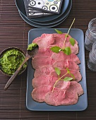 Thai pesto in bowl and roast beef slices on plate