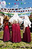 Three woman in costume for procession of Sant 'Efisio in Sardinia, Italy