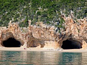 View of two caves from Mediterranean Sea, Cala Luna, Gulf of Orosei, Sardinia, Italy