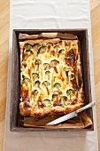 Vegetable quiche with smoked salmon in baking tray, overhead vie3w