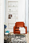 Brown leather armchair in front of white shelving on wall