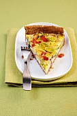 Piece of ham and leek quiche on plate