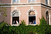 People sitting at window of building in Volksgarten street, Southtown, Cologne, Germany